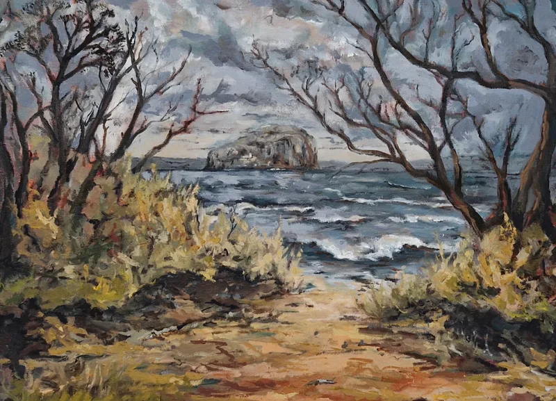 A path between bare twisting trees and dry grasses leading to a grey sea, a rocky island on the horizon
