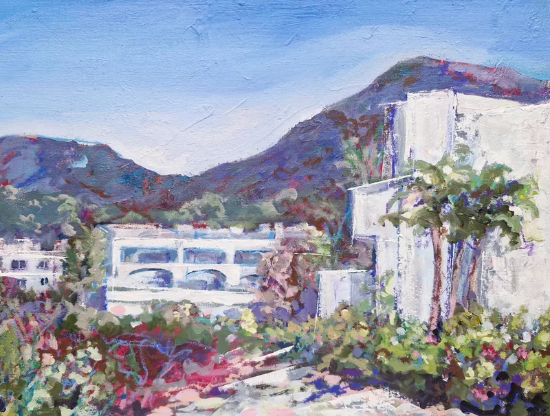 White villas among bright flowers and a palm tree, purple mountains behind under a blue sky